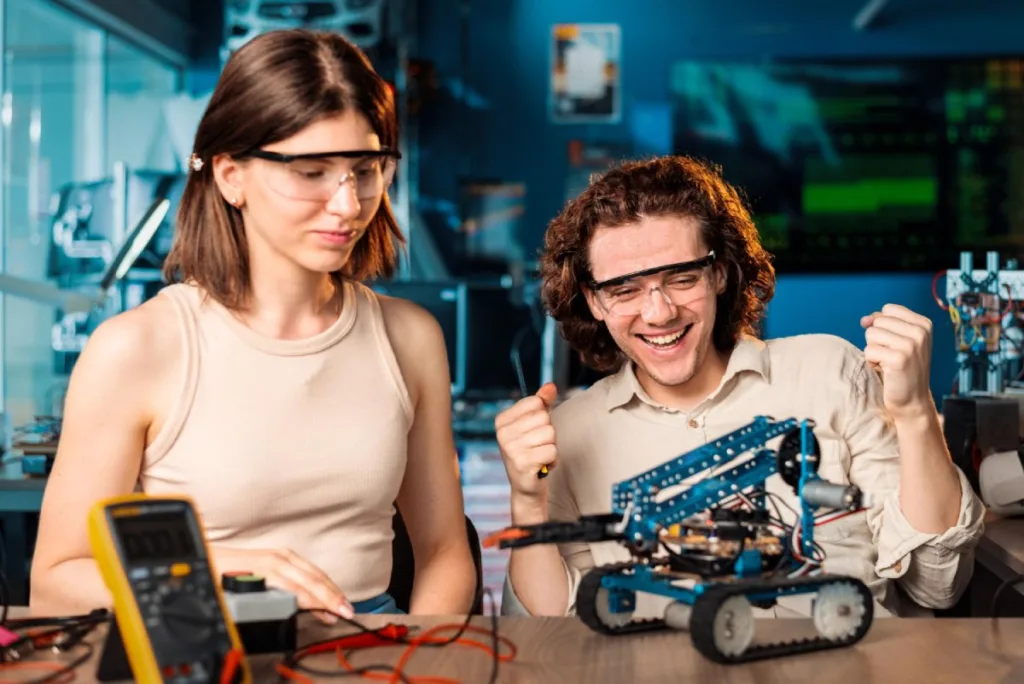 excited young man woman protective glasses doing experiments robotics laboratory